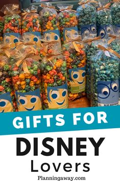 the words gifts for disney lovers are in front of bags of candy