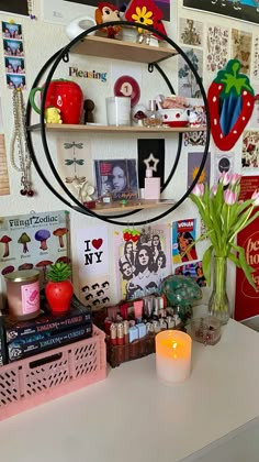 a white desk topped with lots of clutter and a round mirror on top of it