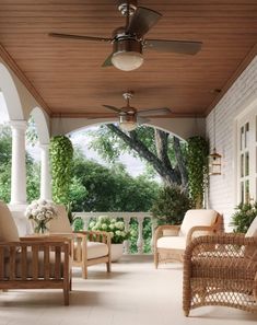 an outdoor covered porch with wicker furniture and ceiling fans on the ceiling, surrounded by greenery