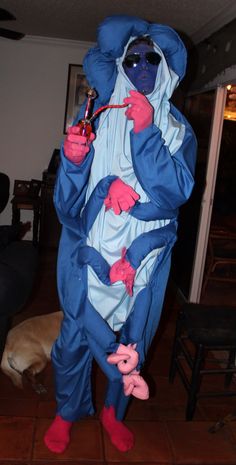 a man dressed in blue and pink is holding a toothbrush