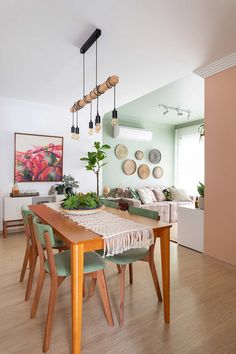 a dining room table with chairs and plants on it