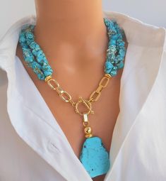 📍 Description :  The handmade multistrand necklace has been designed with genuine raw Turquoise gemstone in asymmetric shape and sizes. 💎Pendant :  Genuine Raw Turquoise gemstones  💥 The colours of the stone may differ slightly in photo shoots caused by lighting and reflections. ✂ Materials : The natural stone used are; Blue Turquoise gemstone in different shapes and sizes. The chain and gold-colored materials used are 14 carat gold plated on brass and do not tarnish. 📐 Dimensions : It has a Turquoise Multistrand Necklace, Double Strand Turquoise Necklace With Gemstone Beads As Gift, Double Strand Turquoise Gemstone Beads Necklace Gift, Elegant Multi-strand Turquoise Necklace Gift, Gift Lariat Turquoise Necklace With Natural Stones, Handmade Turquoise Lariat Necklace For Gift, Handmade Double Strand Turquoise Necklace For Gift, Unique Multi-strand Turquoise Necklace Gift, Artisan Double Strand Turquoise Necklace Gift