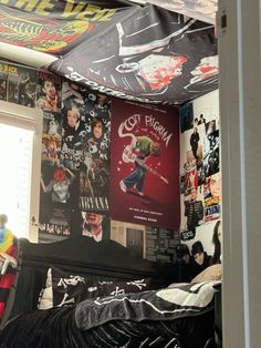 a bedroom with posters on the wall