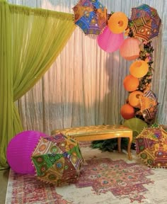 there are many colorful umbrellas on display in this room, including one for the table and two for the chairs