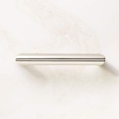 a metal handle on a white marble surface