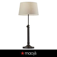 a lamp that is sitting on top of a table next to a white background with the words macy's written below it