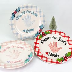 three plates with handprints on them, one for santa and the other for noan