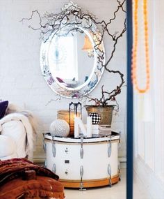 a bedroom with a round mirror on the wall