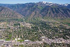 an aerial view of a city with mountains in the background