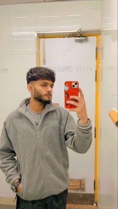 a man taking a selfie in front of a mirror