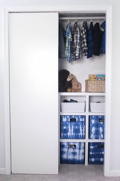 an organized closet with clothes and baskets