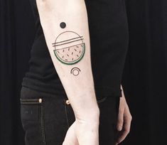 a person with a watermelon tattoo on their arm