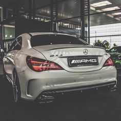 the rear end of a white mercedes car