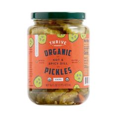 a jar of pickles on a white background with the label organic hot and spicy dill pickles