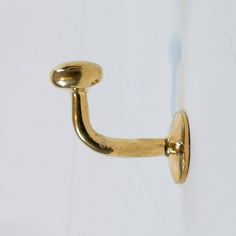 a gold door handle on a white wall