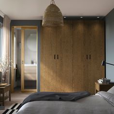 a bedroom with a bed and wooden cabinets