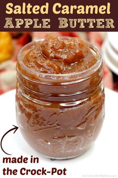 a jar filled with caramel sauce sitting on top of a white plate