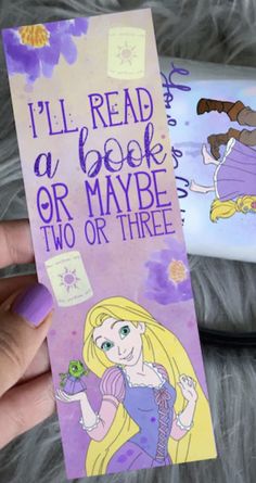 a hand holding up a bookmark with princess aurora and rappui on it