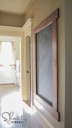 an empty hallway leading to a washer and dryer in a home with white walls