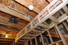 the inside of a room with wooden walls and ladders on the ceiling above it