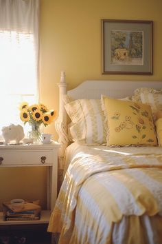 a bedroom with sunflowers in the window and yellow bedding