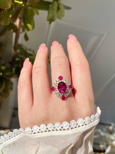 Description:  This ring features a vibrant oval-cut pink topaz in the center, haloed by four small pear-cut pink topaz and multiple sparkling brilliant-cut cubic zirconia stones. The color of this natural pink topaz comes in shades of soft pink and fiery red. As a symbol of love and affection, pink topaz can bring good fortune in love, and provide happiness and vitality to any relationship. It is a great gift for your loved ones and of course a treat for yourself. Pamper yourself and your loved ones! Details: - Stone Name: Pink Topaz - Birthstone: November - Main Stone Shape: Oval - Main Stone Size: 7*9 mm - Metal: Yellow Gold Vermeil / White Gold Vermeil - Due to the nature of gemstones, each piece may slightly vary in color and contain natural inclusions. Also, the color and the halo may Topaz Birthstone, Pink Topaz, Fiery Red, November Birthstone, Love Symbols, Topaz Ring, High Quality Jewelry, Cocktail Rings, Luxury Jewelry