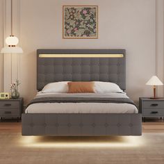 a bedroom with a bed, nightstands and two lamps on either side of the bed