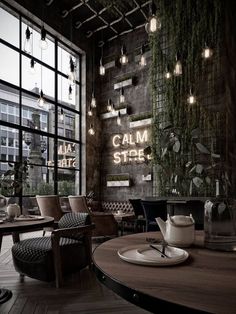 the interior of a restaurant with wooden tables and chairs