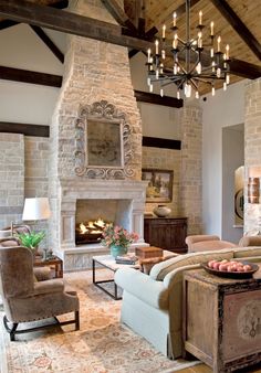 a living room filled with furniture and a fire place in the middle of a room