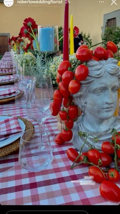 the table is set with tomatoes and candles