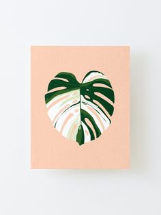 a card with a heart shaped monster plant on the front and green leaves on the back