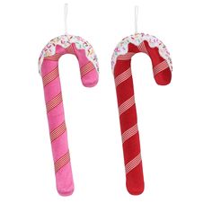 two pink candy canes are hanging from the ceiling and decorated with sprinkles