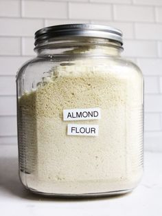 a glass jar filled with flour on top of a white counter