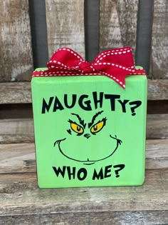 a green box with a red bow on it that says, maugh? who me?