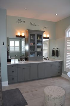 a large bathroom with two sinks and cabinets