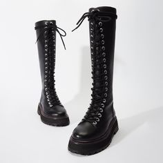 In a silhouette that never goes out of style, the Lara is an edgy new version of the all-time combat boot. With a lug rubber sole and front that laces up high, these are made for sleet and snow, but edgy with a dress any time of year. Edgy Lace-up Boots With Lug Sole And Round Toe, Trendy Lace-up Mid-calf Boots With Lug Sole, Leather Knee-high Lace-up Platform Boots, Black Lace-up Boots For Streetwear, Leather Lace-up Knee-high Platform Boots, Black Combat Boots With Lug Sole For Streetwear, Edgy High Ankle Martin Boots With Lug Sole, Streetwear Lace-up Combat Boots With Reinforced Heel, Fall Knee-high Lace-up Boots With Lug Sole