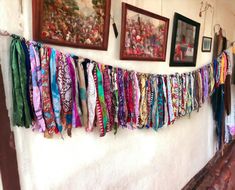 there are many scarves hanging on the wall