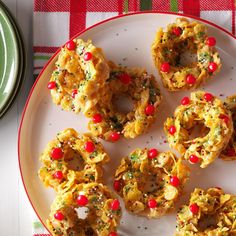 a white plate topped with mini pretzels covered in red and green sprinkles