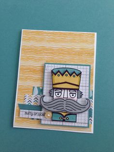 a close up of a card with a mustache and a crown on it's head