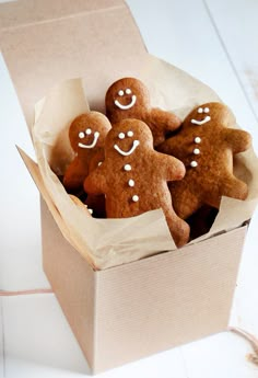 three ginger cookies with white icing in a box