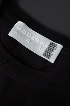 a label on the back of a black t - shirt that says modern arr