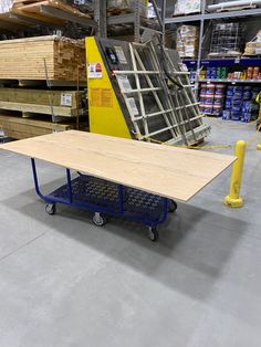 a table sitting on top of a dolly in a warehouse