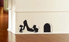 a wall decal with a mouse and high heel shoe on it's side