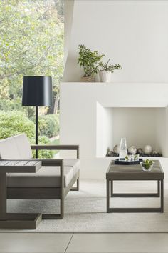 a living room with two couches and a coffee table in front of a fireplace