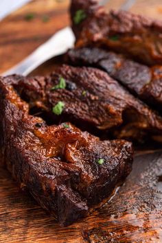 some steaks are on a cutting board with a knife