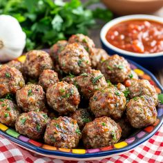 some meatballs are sitting on a plate with sauce and parsley in the background