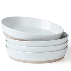 four white bowls stacked on top of each other