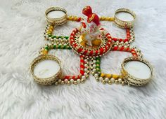 a decorated table with candles and decorations on top of white furnishing in the shape of a cross