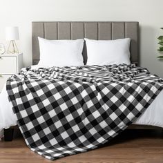 a black and white checkered blanket on top of a bed