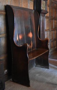 an old wooden bench sitting in front of a wall with mirrors on it's sides